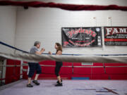 Suzanne Haidri, left, goes through a series of exercises with the help of trainer Jan Beyer at Fisticuffs Gym in Vancouver. Haidri has Parkinson's disease, and boxing has helped improve her strength, speed and balance.