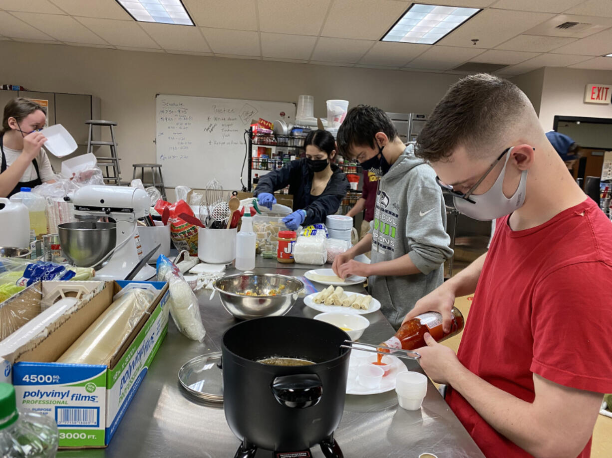 WASHOUGAL: Justus Taylor and Owen Wilkerson make food for the food fair at Washougal High School.