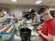 WASHOUGAL: Justus Taylor and Owen Wilkerson make food for the food fair at Washougal High School.