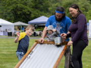 From left: Five-year-old Jacob Mosbach, 11-month-old Maeve DeGrandpre, Adam DeGrandpre and Jemima Dockery play with toy cars during Pomeroy Farm's Farm Days on Saturday in Yacolt. The event gives guests a chance to view the historic grounds and visit with farm animals, artisans and vendors. Farm Days runs the first weekend of each month through August.