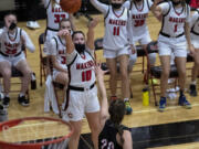 Camas' Katelynn Forner makes a 3-pointer over Union?s Caitlyn Leake while the Papermaker bench celebrates early in the 4A/3A District Championship game on Friday, June 4, 2021, at The Warehouse in Camas. Camas won 77-38.