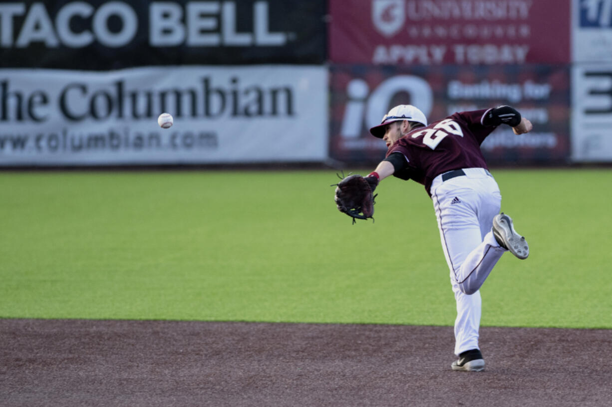 Ridgefield's Tanner Jacques backhand flips the ball out of his glove to start a double play in a West Coast League baseball game on Tuesday, June 8, 2021, at the Ridgefield Outdoor Recration Complex. Ridgefield won 6-3 to improve to 4-0 on the season.