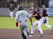 Ridgefield's John Peck readies his throw to first base to complete the double play started by Tanner Jacques? backhand glove flip in a West Coast League baseball game on Tuesday, June 8, 2021, at the Ridgefield Outdoor Recration Complex. Ridgefield won 6-3 to improve to 4-0 on the season.