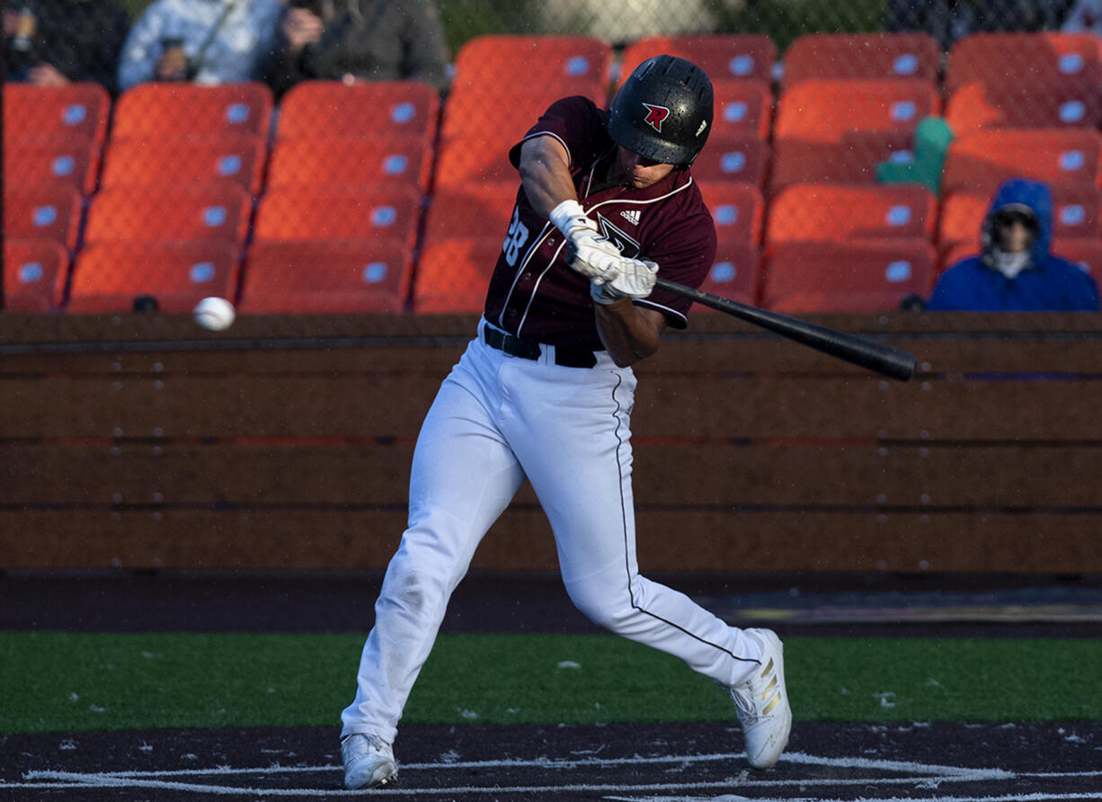 Ridgefield’s Coby Morales swings at a pitch as rain falls in a West Coast League baseball game on Tuesday, June 8, 2021, at the Ridgefield Outdoor Recration Complex. Morales, a Cypress College freshman went 1 for 5 on the night.