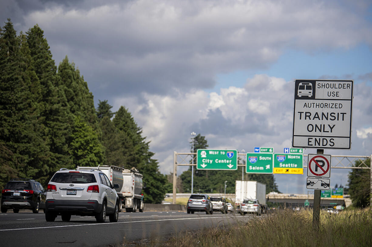 Motorists traveling west on state Highway 14 pass a sign marking the end of the bus-on-shoulder lane. C-Tran buses are currently allowed to use the shoulder to bypass traffic congestion, but an upcoming project to add lanes to the highway will eliminate the bus-only shoulder in favor of a peak-use shoulder open to all vehicles.