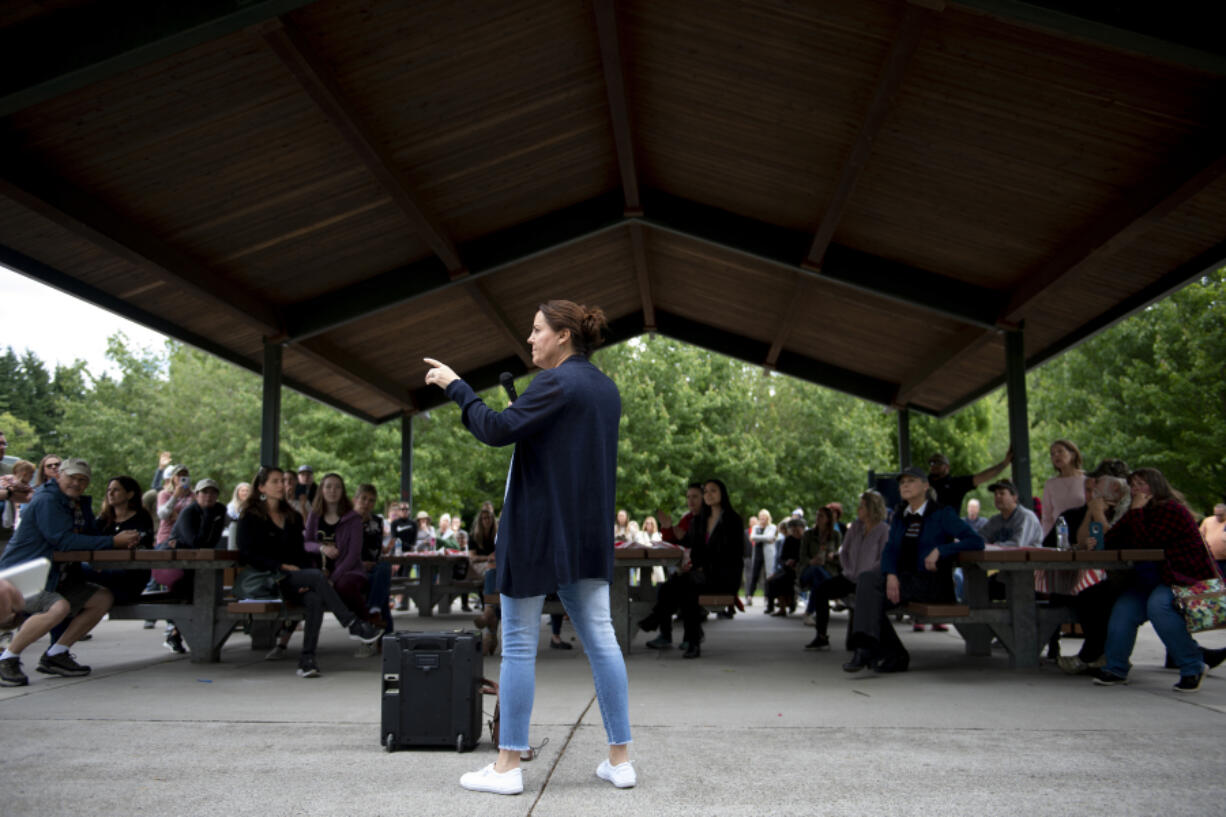 Sen. Ann Rivers, center, takes a question from the crowd as she discusses children and COVID-19 masks at Felida Park on Thursday. Rivers, R-La Center, met with constituents to talk about masks, social distancing and virus testing in schools.