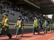 Evergreen High School graduates walk along the track during their graduation ceremony Saturday at McKenzie Stadium.