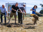 U.S. Rep. Jaime Herrera Beutler, R-Battle Ground, jumps June 4 to avoid dirt thrown by Port of Woodland Commissioner Dale Boon, left, Port of Woodland Commission President Bob Wile, second from the left, and Port of Woodland Commissioner Paul Cline.