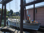 Rick Bishoprick, left, who spent more than 25 years taking the lead on restoring his family's wooden boat, Corahleen, in Washougal and Ridgefield, talks with Loren Decker of Schooner Creek on Hayden Island on Monday morning.