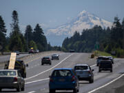 Drivers traveling east on state Highway 14 take in a scenic view as a snowcapped Mount Hood is seen in the distance under sunny skies Thursday. Forecasters expect sunny skies and summer-like temperatures for several days, with temperatures peaking near  100 degrees on Monday.