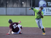 Ridgefield's Tafton Hensley tries to slide to break up a double play converted by Yakima Valley shortstop Connor Caballes with this throw in Tuesday's West Coast League baseball game at the Ridgefield Outdoor Recreation Complex.