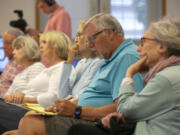 Ken Wilkinson, second from right, takes notes during a candidate forum at Trinity Baptist Church in Vancouver on Tuesday.