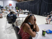 Tracy Jones of Vancouver joins a crowd of local residents at the Living Hope Church cooling center as she escapes the extreme heat on Monday afternoon. The church offered fans, cold drinks, popsicles and snacks. "I'm glad they have something like this. It's rough out there," she said.