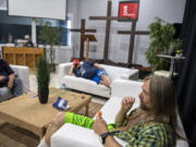 Charles Stuart of Vancouver, right, cools off with an orange popsicle while taking refuge from the heat at the Living Hope Church cooling center on June 28.