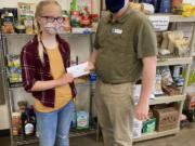 ESTHER SHORT: James Fitzgerald, executive director of nonprofit organization FISH of Vancouver, accepts a donation from 10-year-old Chloe Daarud.