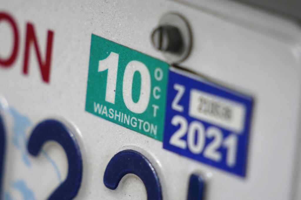 A Washington state car registration tab is shown on a vehicle in Olympia.