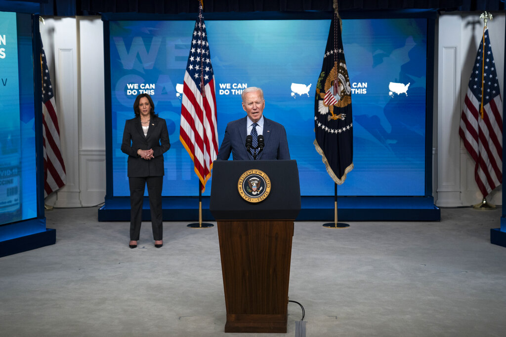 Vice President Kamala Harris listens as President Joe Biden speaks about the COVID-19 vaccination program, in the South Court Auditorium on the White House campus, Wednesday, June 2, 2021, in Washington.