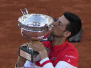 Serbia's Novak Djokovic kisses the cup after defeating Stefanos Tsitsipas of Greece during their final match of the French Open tennis tournament at the Roland Garros stadium Sunday, June 13, 2021 in Paris. Djokovic won 6-7, 2-6, 6-3, 6-2, 6-4.