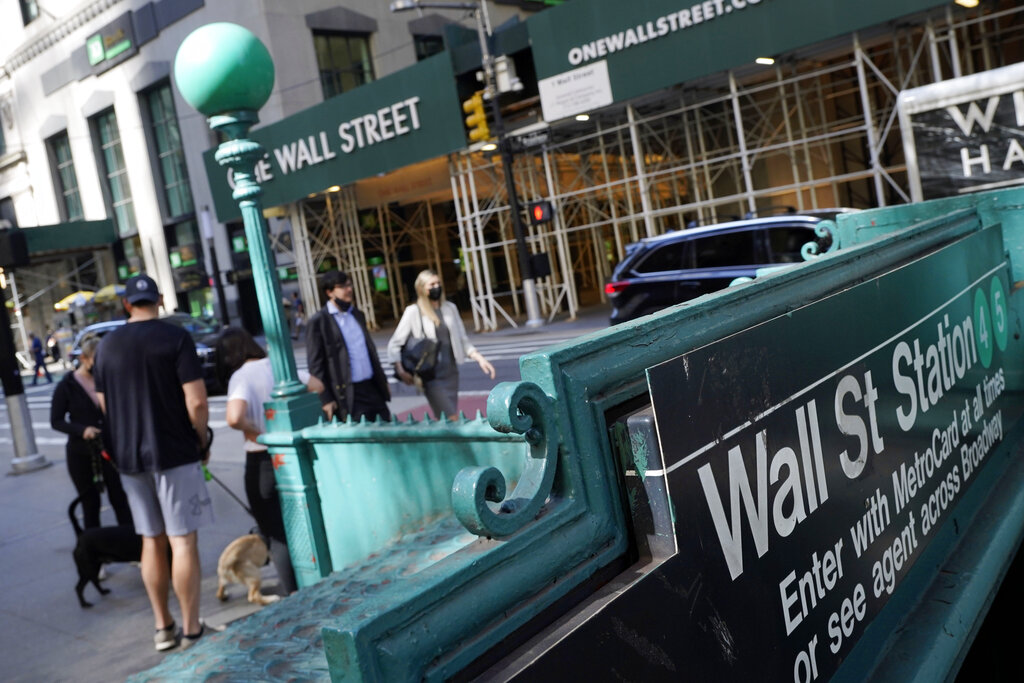 People walk on Broadway at Wall Street, Wednesday, June 16, 2021. Stocks shook off a wobbly start and pushed mostly higher in the first few minutes of trading on Wall Street. The S&amp;P 500 rose 0.1% in the early going Thursday, June 17 and other major indexes were also posting modest gains.