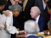 President Joe Biden speaks with Opal Lee after he signed the Juneteenth National Independence Day Act, in the East Room of the White House, Thursday, June 17, 2021, in Washington.