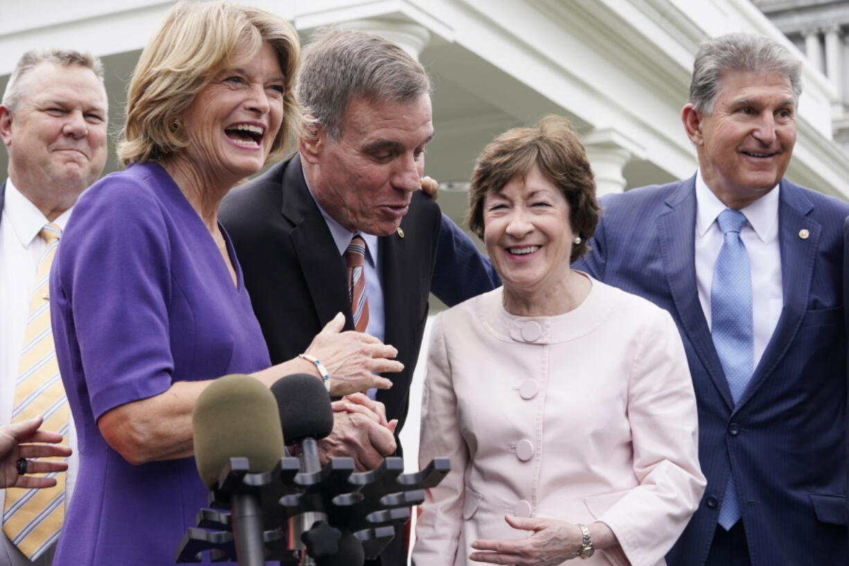 From left, Sen. Jon Tester, D-Mont., Sen. Lisa Murkowski, R-Alaska, Sen. Mark Warner, D-Va., Sen. Susan Collins, R-Maine, and Sen, Joe Manchin, D-W.Va., speak to the media after remarks by President Joe Biden, Thursday June 24, 2021, at the White House in Washington. Biden invited members of the group of 21 Republican and Democratic senators to discuss the infrastructure plan.