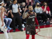 Portland Trail Blazers guard Damian Lillard reacts after making a 3-point basket against the Denver Nuggets during the first half of Game 6 of an NBA basketball first-round playoff series Thursday, June 3, 2021, in Portland, Ore.