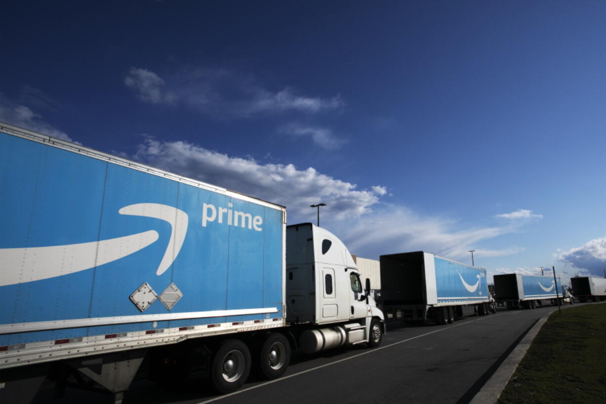 FILE - This April 21, 2020 file photo shows Amazon tractor trailers line up outside the Amazon Fulfillment Center in the Staten Island borough of New York.  Amazon said Wednesday, June 2, 2021,  that it will hold its annual Prime Day over two days in June this year, the earliest it has ever held the sales event.