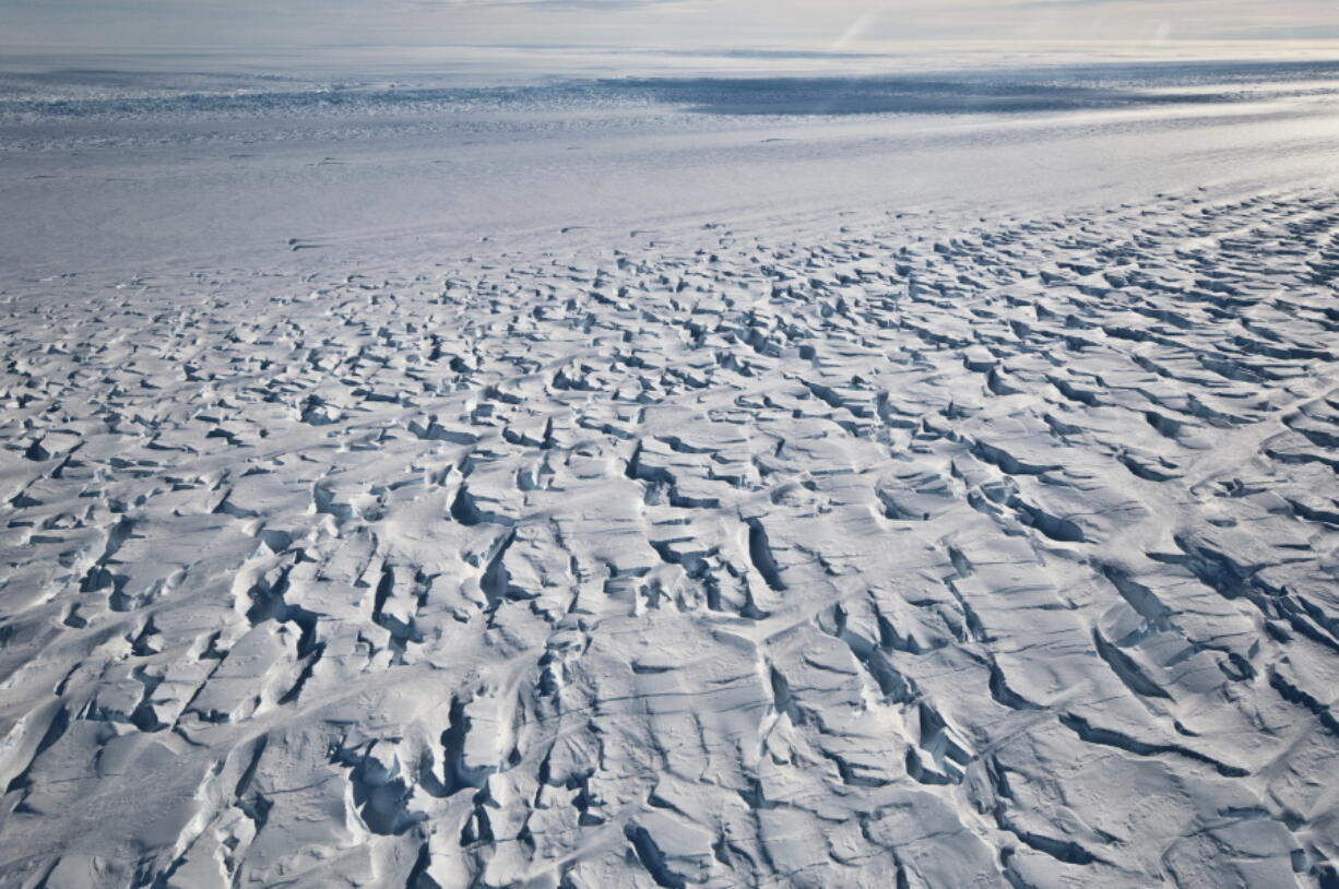 This January 2010 photo provided by Ian Joughin shows the area near the grounding line of the Pine Island Glacier along its west side in Antarctica. According to a study published in the Friday, June 11, 2021 issue of Science Advances, the critical Antarctic glacier is looking more vulnerable as satellite images show the ice shelf that blocks it from collapsing into the sea is breaking up much faster than before and spawning huge icebergs.