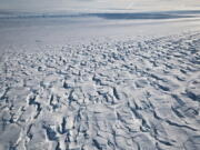 This January 2010 photo provided by Ian Joughin shows the area near the grounding line of the Pine Island Glacier along its west side in Antarctica. According to a study published in the Friday, June 11, 2021 issue of Science Advances, the critical Antarctic glacier is looking more vulnerable as satellite images show the ice shelf that blocks it from collapsing into the sea is breaking up much faster than before and spawning huge icebergs.