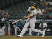 Oakland Athletics' Matt Olson hits a two-run single during the seventh inning of the team's baseball game against the Seattle Mariners, Tuesday, June 1, 2021, in Seattle. (AP Photo/Ted S.