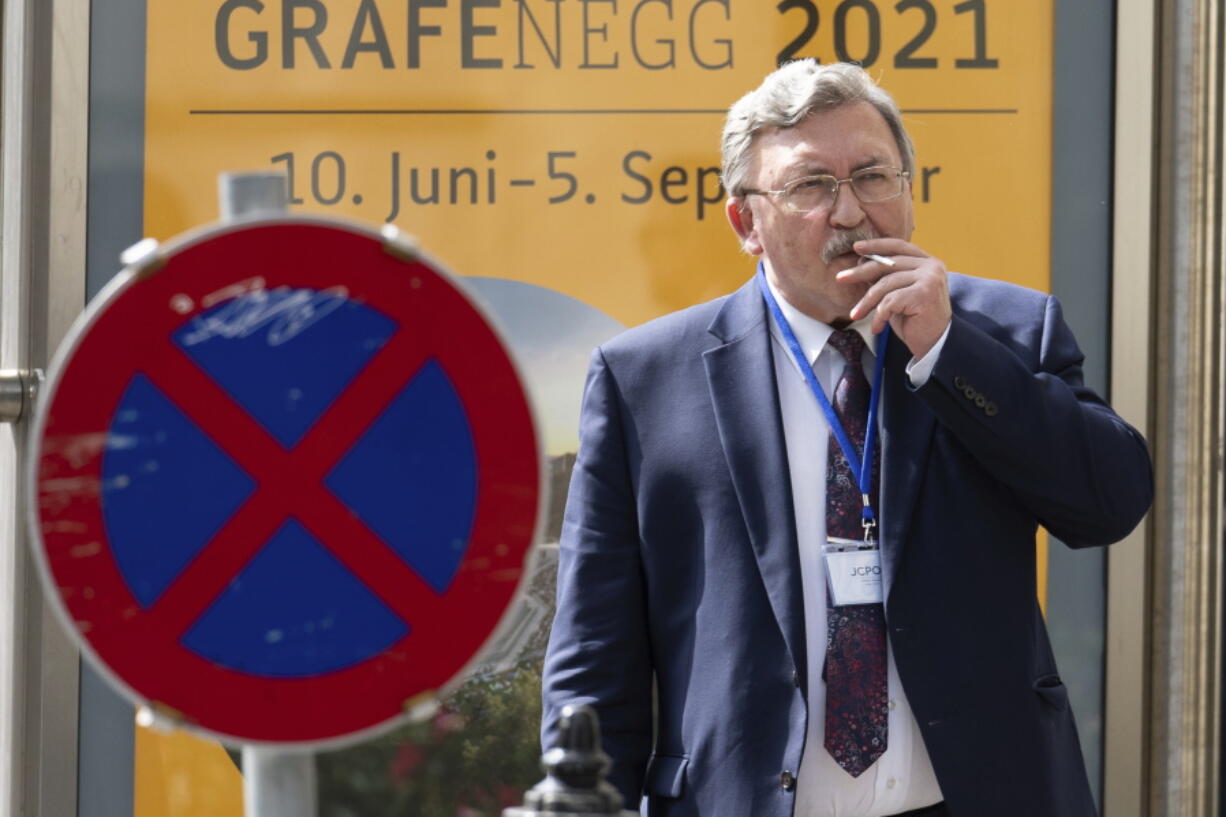 Russia's Governor to the International Atomic Energy Agency (IAEA), Mikhail Ulyanov, smokes a cigarette near the 'Grand Hotel Vienna' where where closed-door nuclear talks take place in Vienna, Austria, Saturday, June 12, 2021.