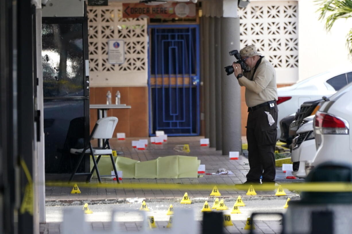 Miami-Dade Police work the scene of a shooting outside of a banquet hall near Hialeah, Fla., Sunday, May 30, 2021. Two people died and an estimated 20 to 25 people were injured in a shooting outside a banquet hall in South Florida, police said. The gunfire erupted early Sunday at the El Mula Banquet Hall in northwest Miami-Dade County, near Hialeah, police told news outlets.