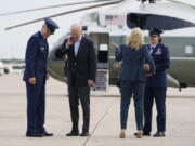 President Joe Biden brushes a cicada from his neck as he and first lady Jill Biden board Air Force One, Wednesday, June 9, 2021, at Andrews Air Force Base, Md. Biden is embarking on the first overseas trip of his term, and is eager to reassert the United States on the world stage, steadying European allies deeply shaken by his predecessor and pushing democracy as the only bulwark to the rising forces of authoritarianism.