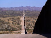 A new border wall stretches along the landscape near Sasabe, Ariz., on Wednesday, May 19, 2021. (AP Photo/Ross D.