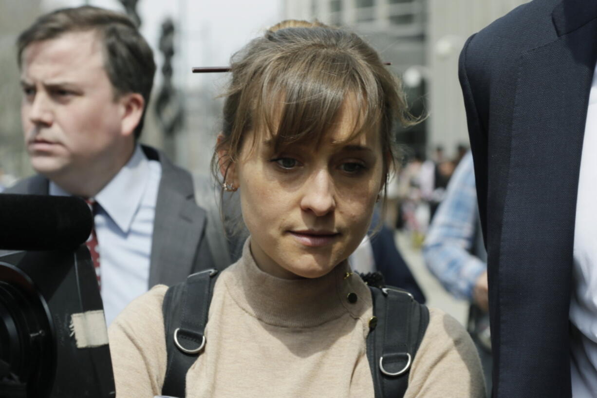 FILE - In this Monday, April 8, 2019, file photo, actress Allison Mack leaves Brooklyn federal court in New York. Mack, who played a key role in a scandal-ridden, cult-like upstate New York group, is facing sentencing Wednesday, June 30, 2021, after pleading guilty to charges she manipulated women into becoming sex slaves for the group's spiritual leader.