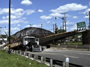 A truck sits under a collapsed pedestrian bridge along Kenilworth Avenue & Polk Street Northeast in Washington, Wednesday, June 23, 2021.