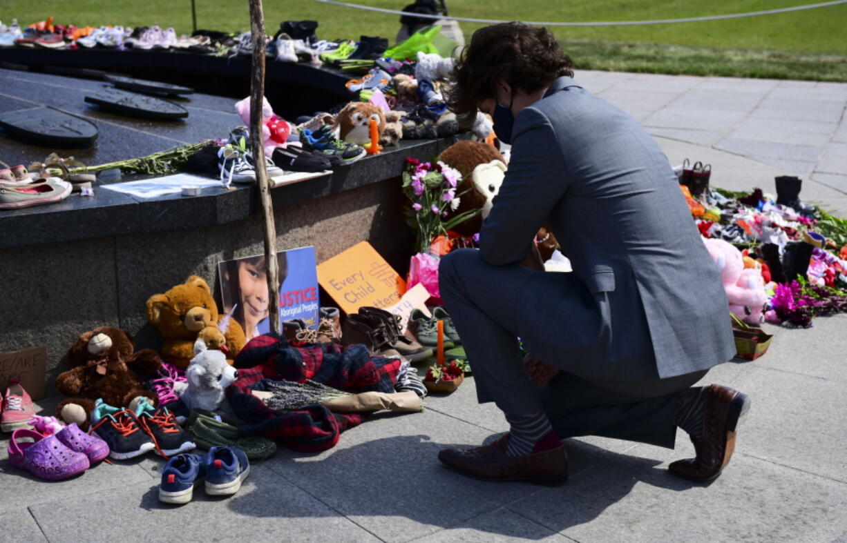 Canadian Prime Minister Justin Trudeau visits a memorial at the Eternal Flame on Parliament Hill in Ottawa on Tuesday, June 1, 2021, that's in recognition of discovery of children's remains at the site of a former residential school in Kamloops, British Columbia.