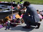 Canadian Prime Minister Justin Trudeau visits a memorial at the Eternal Flame on Parliament Hill in Ottawa on Tuesday, June 1, 2021, that's in recognition of discovery of children's remains at the site of a former residential school in Kamloops, British Columbia.