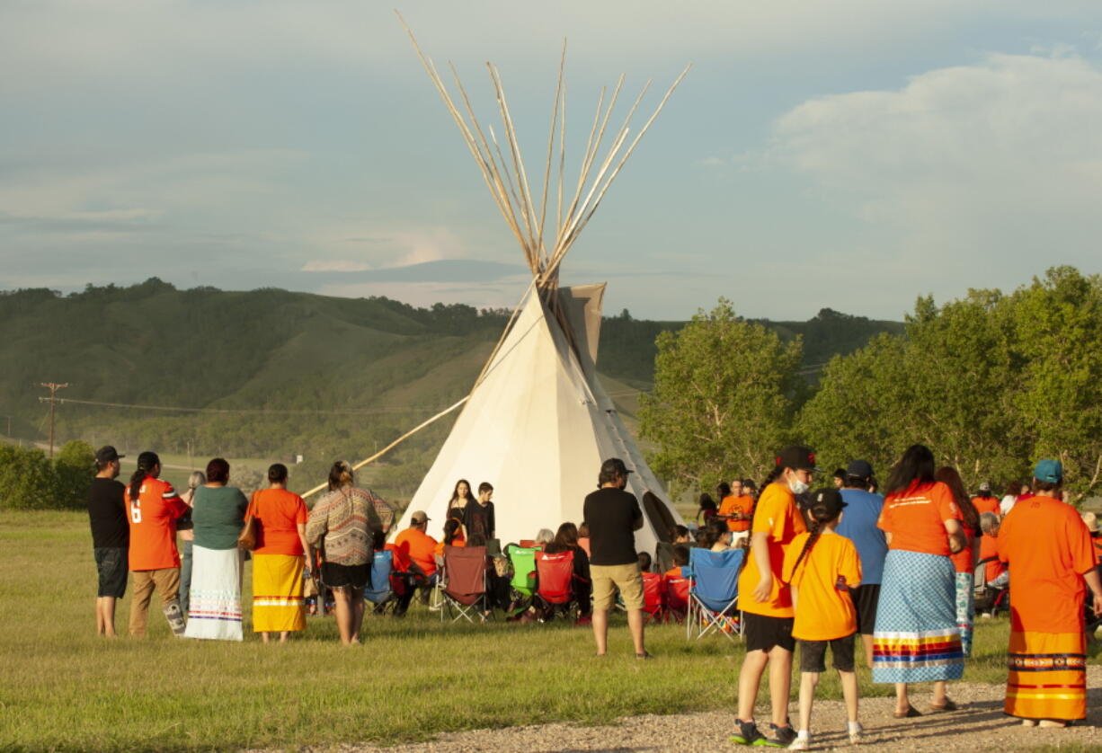 A vigil takes place where ground-penetrating radar recorded hits of what are believed to be 751 unmarked graves near the grounds of the former Marieval Indian Residential School on the Cowessess First Nation, Saskatchewan, Saturday, June 26, 2021.