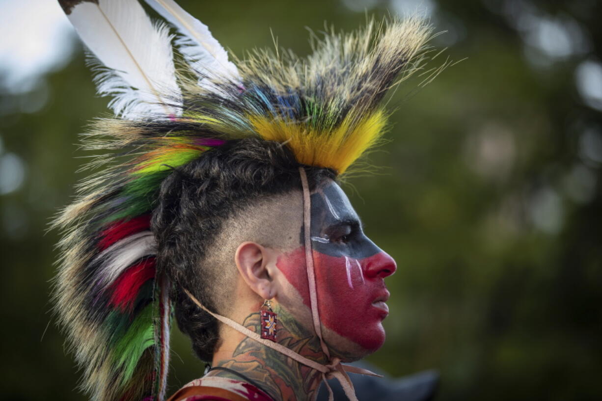 Zachary Orchard, of the Shoal Lake 40 First Nation on the Manitoba and Ontario border, listens during a ceremony and vigil for the 215 children whose remains were found buried at the former Kamloops Indian Residential School, in Vancouver, British Columbia, on National Indigenous Peoples Day, Monday, June 21, 2021.