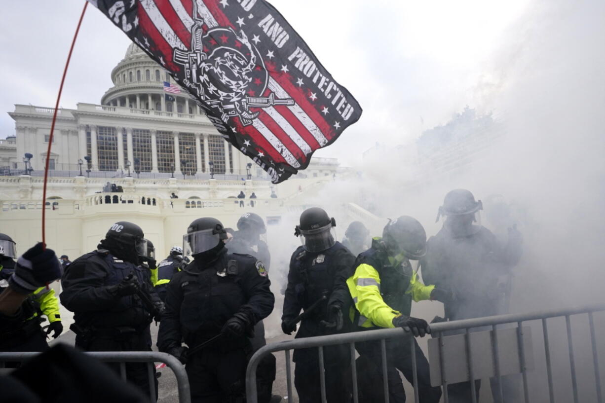 FILE - In this Jan. 6, 2021, U.S. Capitol Police officers hold off rioters loyal to President Donald Trump at the Capitol in Washington.