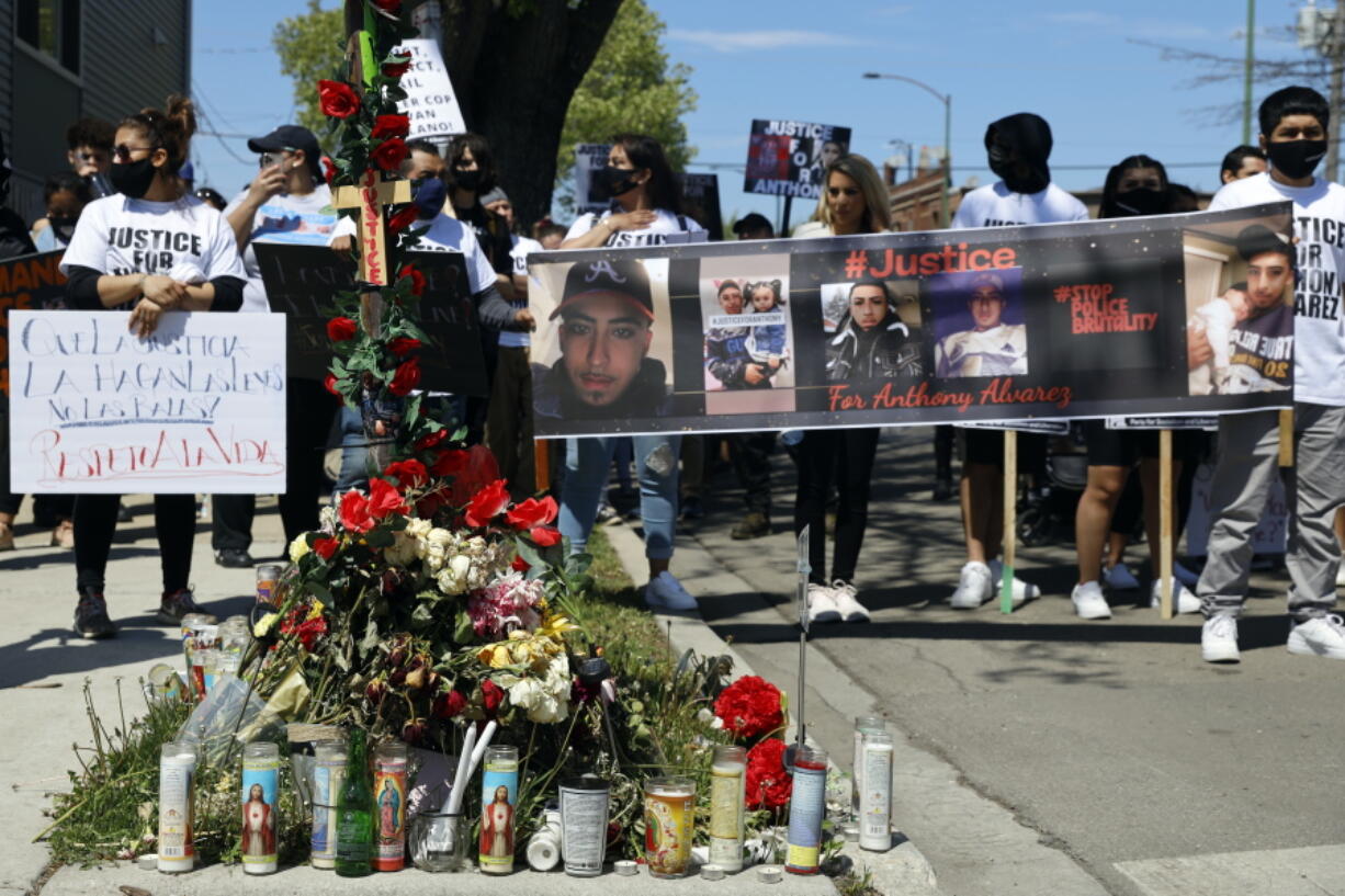 FILE - In this May 1, 2021 file photo, demonstrators remain in solidarity during a protest by the memorial of 22-year-old Anthony Alvarez, who was shot by the police in Chicago. A Chicago Police officer who fatally shot an armed man in the back during a foot pursuit in March has been stripped of his police powers. Police Superintendent David Brown announced the decision to strip Officer Evan Solano of his police powers on Monday, June 28, 2021.