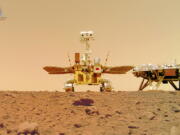 In this image released by the China National Space Administration (CNSA) on Friday, June 11, 2021, the Chinese Mars rover Zhurong is seen near its landing platform taken by a remote camera that was dropped into position by the rover. China on Friday released a series of photos taken by its Zhurong rover on the surface of Mars, including one of the rover itself taken by a remote camera.