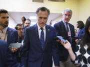 Sen. Mitt Romney, R-Utah, is surrounded by reporters as he walks to the Senate chamber for votes, at the Capitol in Washington, Thursday, June 10, 2021. Sen. Romney is working with a bipartisan group of 10 senators negotiating an infrastructure deal with President Joe Biden. (AP Photo/J.