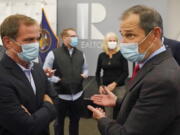 FILE - In this Nov. 3, 2020, file photo, Republican Reps. Chris Stewart, left, and John Curtis talk during an Utah Republican election night party in Sandy, Utah. Curtis is leading a new Conservative Climate Caucus for House Republicans.