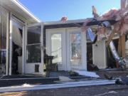 Damage scatters the rear of Tim Long's home in Ocean Isle Beach, N.C., Feb. 16, 2021, following a tornado that struck the area the previous night. The twister that hit Ocean Isle Beach in February killed three people and injured about 10 others.