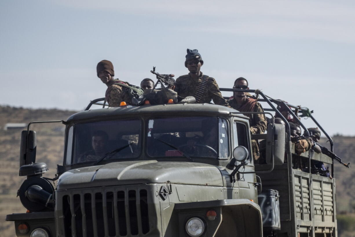 FILE - In this Saturday, May 8, 2021 file photo, Ethiopian government soldiers ride in the back of a truck on a road near Agula, north of Mekele, in the Tigray region of northern Ethiopia. Ethiopia's government said in a statement carried by state media Monday, June 28, 2021, that it has "positively accepted" a call for an immediate, unilateral cease-fire in its Tigray region after nearly eight months of deadly conflict.