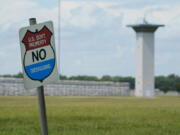 FILE - In this Aug. 28, 2020, file photo, a no trespassing sign is displayed outside the federal prison complex in Terre Haute, Ind. Over the past 18 months, 29 prisoners have escaped from federal lockups across the U.S. - and nearly half still have not been caught.