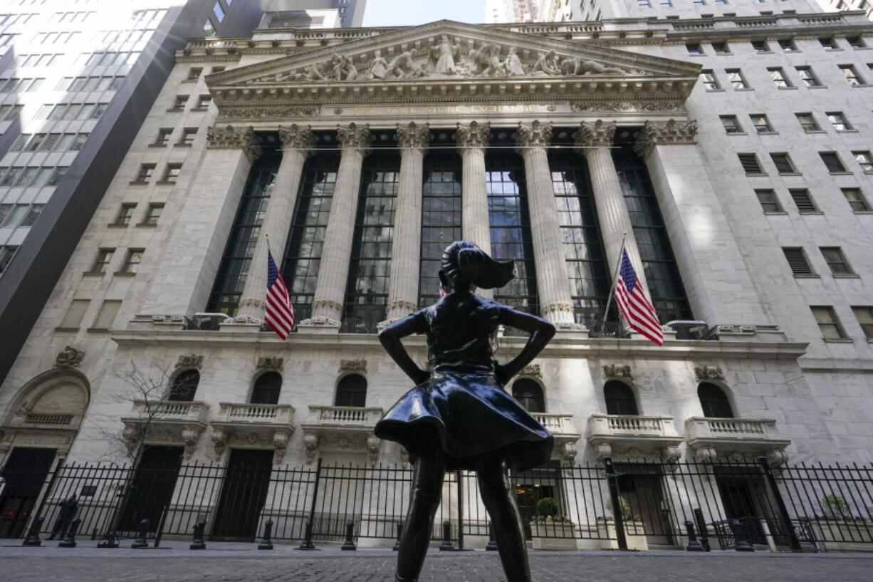 FILE - In this March 23, 2021 file photo, the Fearless Girl statue stands in front of the New York Stock Exchange in New York's Financial District. Stocks are opening broadly higher on Wall Street, getting June off to a strong start as traders returned from the Memorial Day holiday in the U.S.