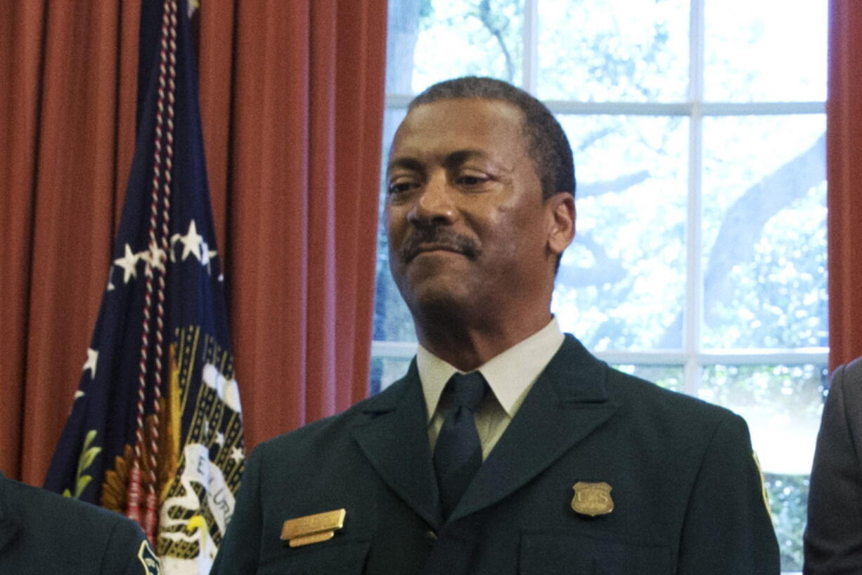 FILE - In this July 10, 2015, file photo Randy Moore, of the U.S. Forest Service, listens as President Barack Obama talks about the designation of three new national monuments in the Oval Office of the White House in Washington. Veteran forester Randy Moore has been named chief of the U.S. Forest Service, the first African American to lead the agency in its 116-year history.